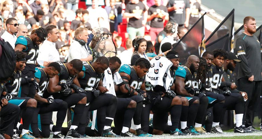 NFL players kneel in protest during the national anthem at the Jacksonville Jaguars vs Baltimore Ravens game.